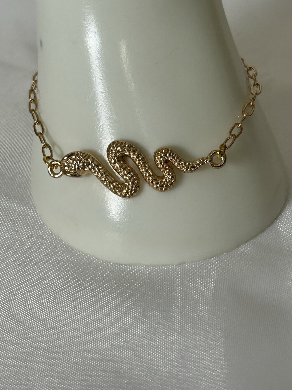 Gold Tone Snake Bracelet. Measures 8”